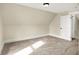 Bedroom featuring neutral walls, dormered ceilings, and a classic door at 462 W Broadway St, Greenwood, IN 46142