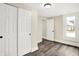 Cozy bedroom with neutral walls, wood-look floors, closet space and view of exterior of home at 462 W Broadway St, Greenwood, IN 46142