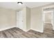 Neutral bedroom featuring wood-look flooring, fresh paint and a large closet at 462 W Broadway St, Greenwood, IN 46142