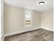 Comfortable bedroom featuring neutral colors, wood-look flooring, and natural light from large windows at 462 W Broadway St, Greenwood, IN 46142