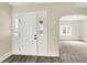 Bright entryway with white trim, gray wood-look floors, and an arched doorway to the living room at 462 W Broadway St, Greenwood, IN 46142
