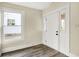 Bright entryway with gray wood-look floors, a front door, and a large window at 462 W Broadway St, Greenwood, IN 46142