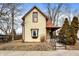 Charming two-story home with yellow siding, a red roof, and well-maintained landscaping at 462 W Broadway St, Greenwood, IN 46142