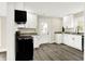White kitchen featuring stainless appliances, wood floors, and granite countertops at 462 W Broadway St, Greenwood, IN 46142