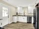 Updated kitchen featuring new stainless appliances, granite counters, and white cabinets, all freshly painted at 462 W Broadway St, Greenwood, IN 46142