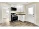 Stylish kitchen with stainless steel appliances, granite counters, and a charming white exterior door at 462 W Broadway St, Greenwood, IN 46142