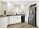Bright kitchen with granite countertops, stainless appliances, white cabinetry, and wood-look floors at 462 W Broadway St, Greenwood, IN 46142