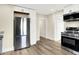 Stainless refrigerator and appliances in white kitchen with wood floors at 462 W Broadway St, Greenwood, IN 46142
