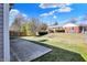 View of the backyard with a patio and lawn on a partly cloudy day at 4722 Common View Cir, Indianapolis, IN 46220