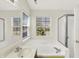 Bright bathroom featuring double windows, shower and tub combination, neutral colors and a spacious layout at 4722 Common View Cir, Indianapolis, IN 46220