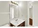 Bathroom featuring a vanity, mirror, light fixture, and doorway with view of the hall at 4722 Common View Cir, Indianapolis, IN 46220