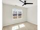 Bedroom featuring carpeted floors, a black ceiling fan, and a window with mini blinds at 4722 Common View Cir, Indianapolis, IN 46220