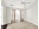 Bright and airy bedroom showcasing neutral walls, a ceiling fan, a dark brown cabinet and natural light at 4722 Common View Cir, Indianapolis, IN 46220