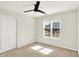 Bedroom with large window, carpet flooring, ceiling fan, and closet at 4722 Common View Cir, Indianapolis, IN 46220