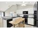 Bright kitchen featuring white cabinets, subway tile backsplash and modern black appliances at 4722 Common View Cir, Indianapolis, IN 46220