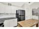Contemporary kitchen with white cabinets, stainless steel appliances, and convenient laundry room access at 4722 Common View Cir, Indianapolis, IN 46220