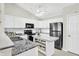 Bright kitchen featuring white cabinets, stainless steel appliances, and granite countertops at 4722 Common View Cir, Indianapolis, IN 46220
