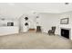 Spacious living room with fireplace, neutral carpet, and open layout connecting to the kitchen at 4722 Common View Cir, Indianapolis, IN 46220