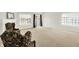 Spacious carpeted living room featuring a fireplace and sliding glass doors for lots of natural light at 4722 Common View Cir, Indianapolis, IN 46220