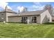 The backyard features a well-maintained lawn, patio area, mature trees, and fire pit creating a perfect outdoor space at 4732 Ashfield Dr, Westfield, IN 46062