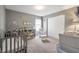 Neutral bedroom provides a cozy space, complete with a crib, chair, and ample storage at 4732 Ashfield Dr, Westfield, IN 46062