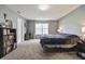 Bright primary bedroom features neutral walls and carpet, complemented by ample natural light from windows at 4732 Ashfield Dr, Westfield, IN 46062