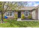 Close up of charming home with brick facade, blue shutters, and landscaped front yard with a mature tree at 4732 Ashfield Dr, Westfield, IN 46062