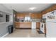 Functional kitchen with wood cabinetry, white appliances, and ample counter space at 4732 Ashfield Dr, Westfield, IN 46062