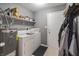 Functional laundry room equipped with washer, dryer, and shelving, providing ample storage at 4732 Ashfield Dr, Westfield, IN 46062