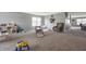 Spacious playroom with neutral carpet and a comfortable reading chair near the opening to the other room at 4732 Ashfield Dr, Westfield, IN 46062