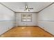 This bedroom features hardwood floors, a window, neutral walls, and a ceiling fan at 477 S Restin Rd, Greenwood, IN 46142