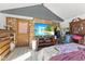 Bedroom featuring a brick wall, a mounted TV, and hardwood floors at 477 S Restin Rd, Greenwood, IN 46142