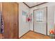 Inviting entryway with hardwood floors, coat hooks, a wooden door and transom window at 477 S Restin Rd, Greenwood, IN 46142