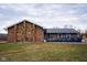 Charming single-story home featuring a blend of brick and stone, a ramp, and a well-maintained front lawn at 477 S Restin Rd, Greenwood, IN 46142