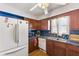 Kitchen featuring wood cabinets, white appliances, and double basin sink under a window at 477 S Restin Rd, Greenwood, IN 46142