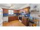 Traditional kitchen featuring wood cabinets, laminate countertops, and white appliances at 477 S Restin Rd, Greenwood, IN 46142
