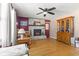 Cozy living room with brick fireplace, hardwood floors, and a ceiling fan at 477 S Restin Rd, Greenwood, IN 46142