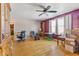 Spacious living room with hardwood floors, a ceiling fan, and natural light from the windows at 477 S Restin Rd, Greenwood, IN 46142