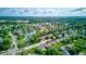 Panoramic aerial view showcasing a neighborhood, featuring lush greenery, a serene lake, and well-maintained homes at 4889 Oakleigh Pkwy, Greenwood, IN 46143