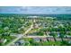 Expansive aerial view showcasing a neighborhood's layout with ponds and proximity to the local high school at 4889 Oakleigh Pkwy, Greenwood, IN 46143