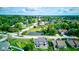 Picturesque aerial view of a peaceful neighborhood, featuring well-maintained homes, a tranquil pond, and lush greenery at 4889 Oakleigh Pkwy, Greenwood, IN 46143