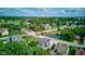 Stunning aerial view of a lush residential neighborhood featuring mature trees and a serene pond at 4889 Oakleigh Pkwy, Greenwood, IN 46143