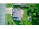 An overhead shot of a backyard including a fire pit and trampoline, showcasing a large grassy area and mature trees at 4889 Oakleigh Pkwy, Greenwood, IN 46143