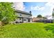 A large, grassy backyard featuring a concrete patio and a privacy fence at 4889 Oakleigh Pkwy, Greenwood, IN 46143