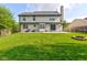Large backyard featuring a well-maintained lawn, patio, and fire pit, perfect for outdoor entertaining and Gathering activities at 4889 Oakleigh Pkwy, Greenwood, IN 46143