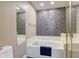 Bathroom features a soaking tub with decorative tile accent wall and bright vanity lights at 4889 Oakleigh Pkwy, Greenwood, IN 46143