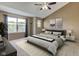 This bright bedroom has carpeted floors, a ceiling fan, large window, and a neutral color palette at 4889 Oakleigh Pkwy, Greenwood, IN 46143