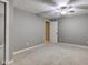 Empty bedroom with a large mirror and neutral colored walls and carpet at 4889 Oakleigh Pkwy, Greenwood, IN 46143