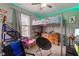 A brightly lit bedroom with green led accent lighting, features a loft bed and a wooden dresser at 4889 Oakleigh Pkwy, Greenwood, IN 46143