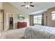 This bedroom offers a ceiling fan, closet, dresser, and a large window for natural lighting at 4889 Oakleigh Pkwy, Greenwood, IN 46143